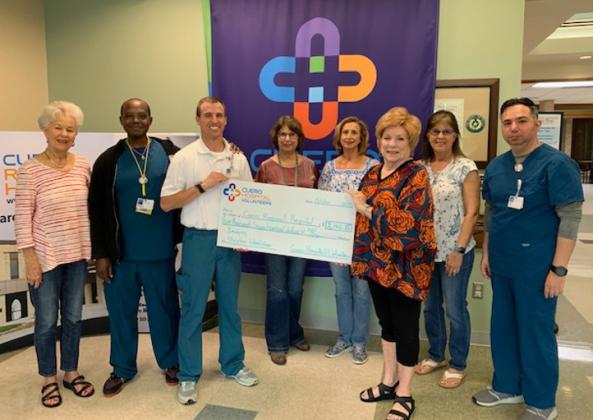 Emily Davis, Ron Lewis, Nuclear Medicine Technologist, Tyler Lemke, Director of Imaging, Sondra Wineinger, Kristy Kahlich, Cindy Holcomb, Kaye Lane, and Jairo Garcia, Radiologic Technologist. A check for $3700.00 was given to purchase a wheelchair for the Imaging department.