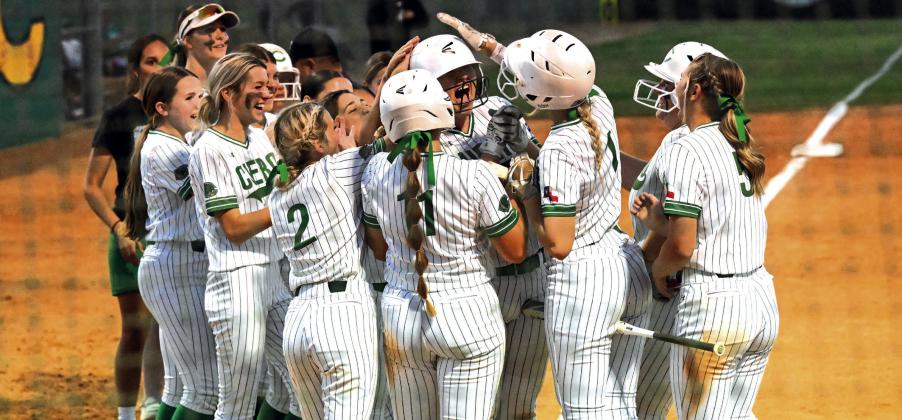 The Lady Gobblers celebrate Julianna Cox’s home run at the plate.