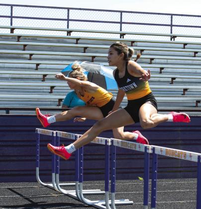 Yorktown junior Nina Villarreal goes over a hurdle on her way to winning the 100m Hurdles. CONTRIBUTED PHOTO