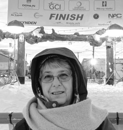 Deborah Granberry pauses in front of the Iditorad finish line, where Alaska Missions has one of its many service events.