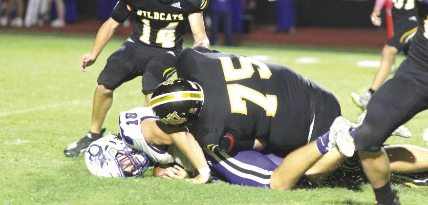 Landon Wilkes tackles an opposing player in Friday’s matchup. PHOTO BY DEIRDRE ALEXANDER