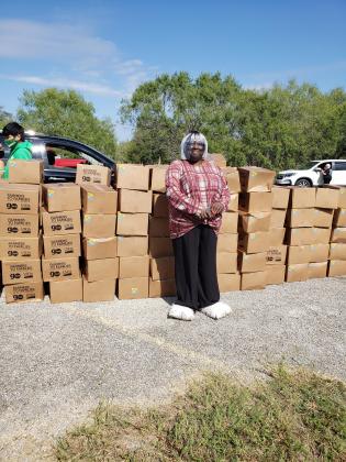 Viola Holman of the Tri-City Empowerment Council and Daule Community stands next to food delivered in Cuero on Oct. 24.