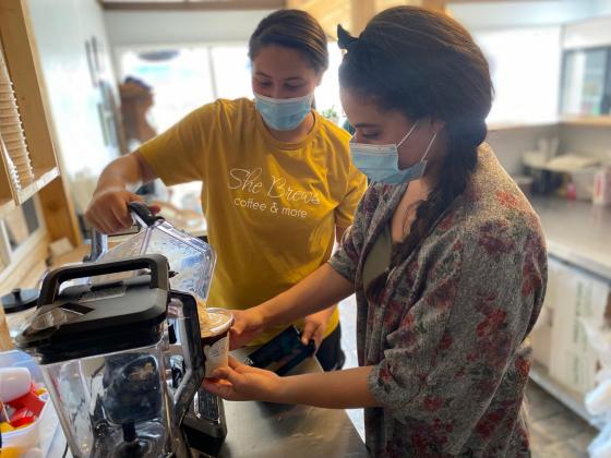 Taylor Watson (right) offers a helping hand to her sister, Tory Littles as she pours a drink at their new coffee shop, She Brews, located at 112 East Morgan Street in Cuero. 