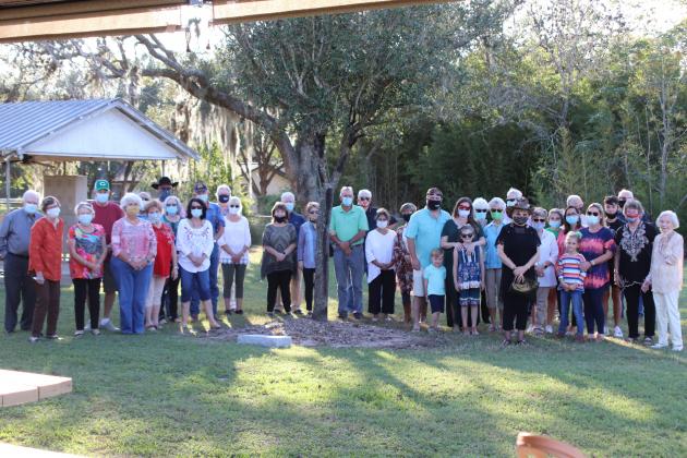 Cuero Country Club Board members and guests pose for a group photo with the newly planted tree at the County Club in honor of longtime manager Jim Warner.