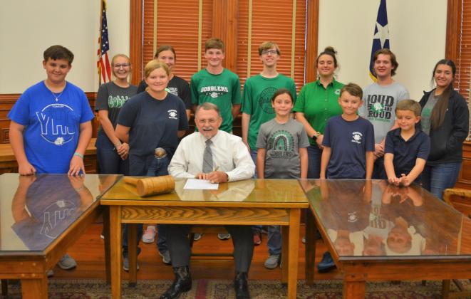 (Back from left) Jackie Finney, Ella Jander, J.R. Bishop, Robert Post, Kaylynn Cowey, T.C. Simon, Kassidy Cowey, (Front from left) Gunnar Frank, Kaitlyn Roeder, Judge Fowler, Lynzi Brandstetter, Carter Roeder and Eli Roeder pose with DeWitt County Judge Daryl Fowler as he recognizes the first week of October as National 4-H Week Sept. 26.