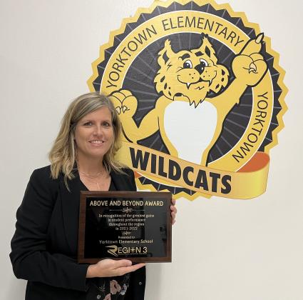 Yorktown Elementary School Principal Laura Patek holds the award received from ESC Region 3 for the greatest gains in student performance.  