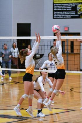 Emie Bolting and Junior Kendyll Sinast go up for a block.