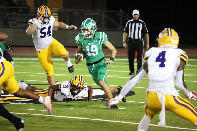 Junior quarterback Mason Notaro runs past several La Grange Leopard defenders in last Thurs- day’s district championship at Gobbler Stadium. Notaro had a total of 125 yards of offense to pair with a rushing and passing touchdown in the 49-7 win.