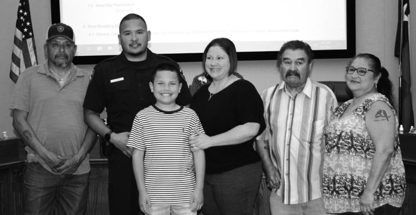 New Police Officer Johnathan Banda is surrounded by his family after recognition at the Cuero City Council. (Staff photo)
