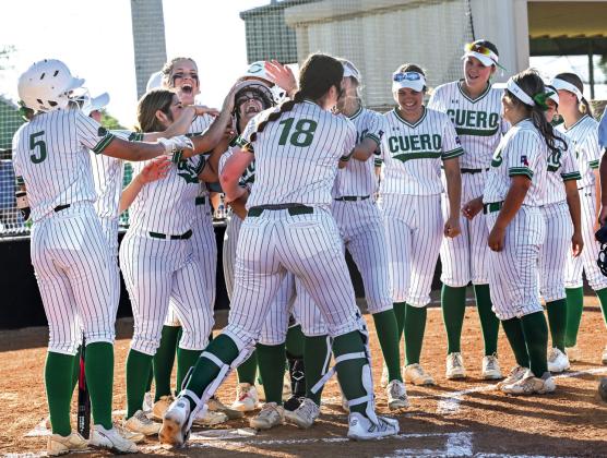 The Lady Gobblers celebrate Lainee Ballin's homerun, which put Cuero's first run on the board.