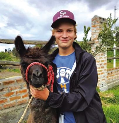 4-H Ambassador Andrew Hahn of Yorktown makes a new friend in Ecuador. CONTRIBUTED PHOTO
