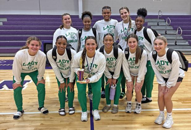 Your Lady Gobblers proudly display the trophy they won at the Navarro Invitational Tournament, where they went 4-1 in tournament play.