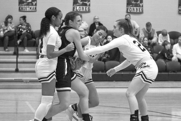 Kitty Kats Brilye Campbell (left), Destiny Longoria (middle) and Laynie Boyd (right) sandwich a Port Aransas player during Friday night’s game. CONTRIBUTED PHOTO