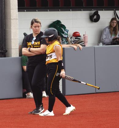 Kitty Kat head softball Courtney Clark gives instructions to freshman Amaya Luna, as she goes to bat. CONTRIBUTED PHOTO