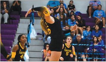 Freshman Kendall Sievers jumps to spike the ball, while Brilye Campbell (left) and Kendyll Sinast (right) look on. CONTRIBUTED PHOTO