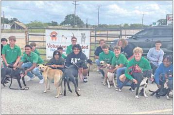 Gobblers athletes share their time and especially their love with animals at Pet Adoptions of Cuero. Their canine parade is a sight to behold.