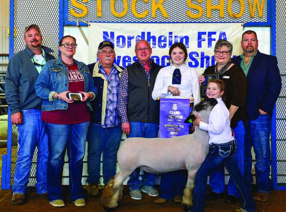 Grand Champion Lamb – Tessa Garcia, 3rd grade Buckle Sponsor: Roman Sager and Tanya Stehle; Buyers: Ray Leister - Nordheim FFA Fundraisers, Bobby Strieber, Connie Imes – representing Citizens Bank; Jeff Massey – Massey Funeral Home. Carly Metting holding banner, Tessa Garcia – exhibitor, Not Pictured: Gordon and Billie Reynolds – Speaker Sponsor.