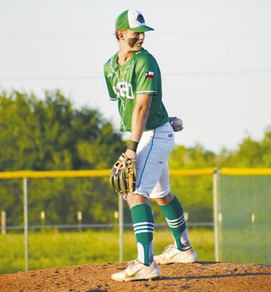 Cuero pitcher, William Carbonara, checks the runner on first in the Gobblers game against La Vernia. PHOTO BY COURTNEY KUBESCH