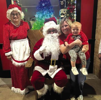Santa poses with Carla Sullivan and Bexlee Blaschke.