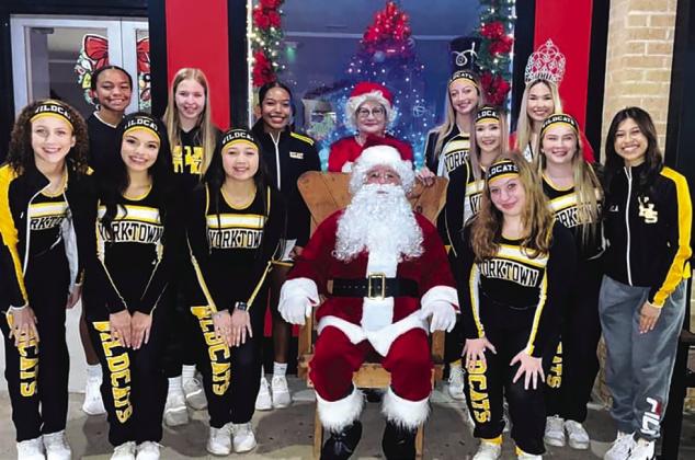 Varsity Wildcat Cheerleaders poses with Santa.
