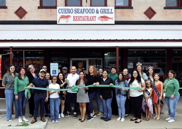 The Cuero Chamber of Commerce celebrated the grand opening of Cuero Seafood and Grill with a ribbon-cutting ceremony on March 13. Owner Bountai “Tai” Yan and his wife, Niti, stand behind the bow. This is the second seafood restaurant opened by the Yans; the first one opened in Edna, 7 years ago.