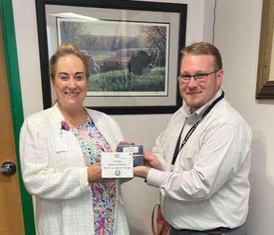 Katie Bowen, Principal at Cuero High School, accepts $125 gift cards for campus teachers from Sean P. Douglas, Executive Director of the Cuero ISD Education Foundation. Contributed photo.