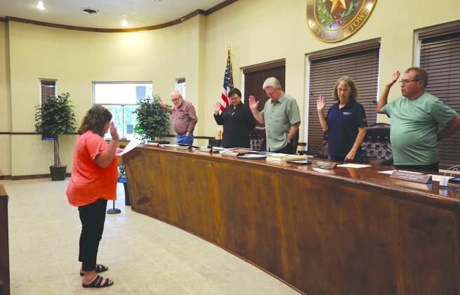 City Administrator Michelle Warwasmswears in City Council members, from left: James O’Connell, Mary Kay Mattox, Mayor Bill Baker, Connie Hall and Dickey Rodriguez PHOTO BY KIMBER McCRORY