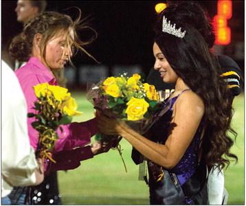 2018 Homecoming Queen Jasmin Davis (left) presents 2023 Homecoming Queen Addison Rosales flowers after crowning her.. CONTRIBUTED PHOTO