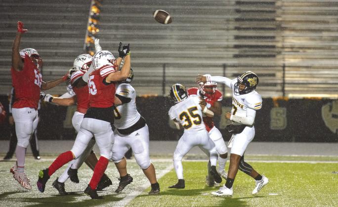 Jayden Rodriguez looks to throw downfield while linemen Hall and Nunez block. PHOTOS BY: JAYMIE KNOSTMAN