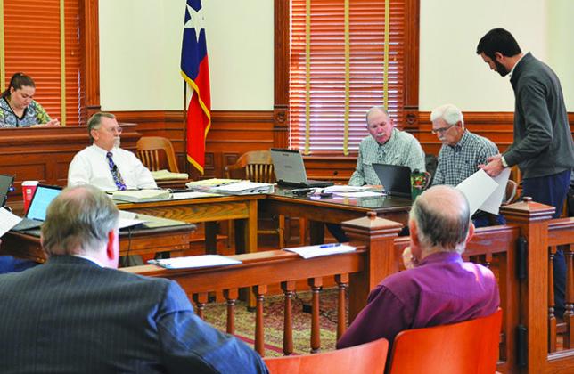 Consultant Garrett Peters (far right) presents information to commissioners Curtis Afflerbach and Brian Carson last Monday, Jan. 23. PHOTO CONTRIBUTED BY HANS LAMMEMAN
