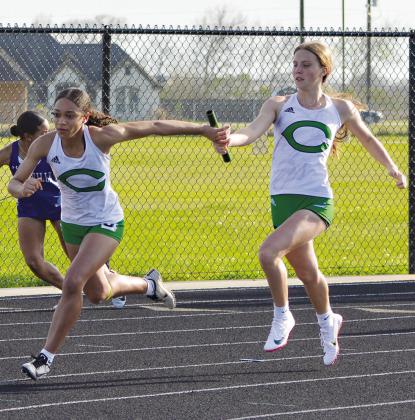 Taryn Gayle is handing the baton off to Mauryana Dasilva in the 4x100 relay. This relay won 1st place with a time of 49.49. PHOTOS BY COURTNEY KUBESCH