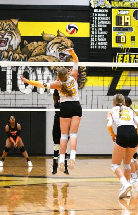 Sophomore Carly Weischwill spikes a ball at the net. CONTRIBUTED PHOTO