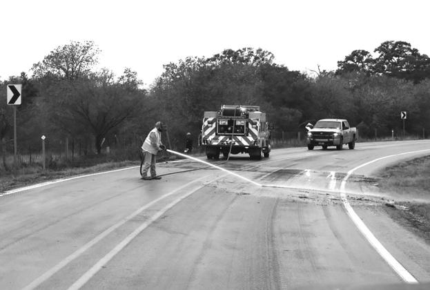 Fireman Rodriguez removes debris from FM 237. CONTRIBUTED PHOTO