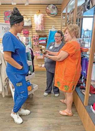 Cuero Regional Hospital volunteer, Cindy Holcomb, assists Laura Comiskey and Danielle Rathkamp in selecting a gift from the Wishing Well gift shop. The shop is located at the front of the hospital and is open to the public from 10 a.m. to 4 p.m. Tuesday through Friday. Contributed Photo