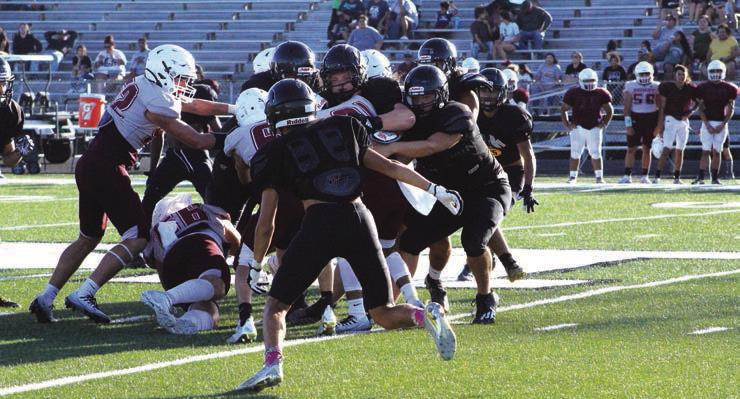 A host of Wildcats stop a Kenedy ball carrier during the Kenedy scrimmage. PICTURE CONTRIBUTED BY JAYMIE KNOSTMAN