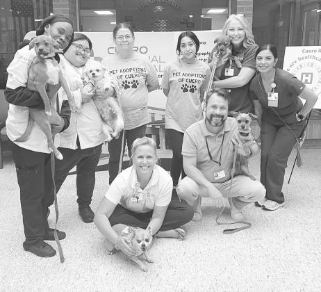 Cuero Regional Hospital employees pose with dogs from Pet Adoptions of Cuero recently.