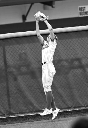 Centerfielder, Lexi Flessner, catches a fly ball.